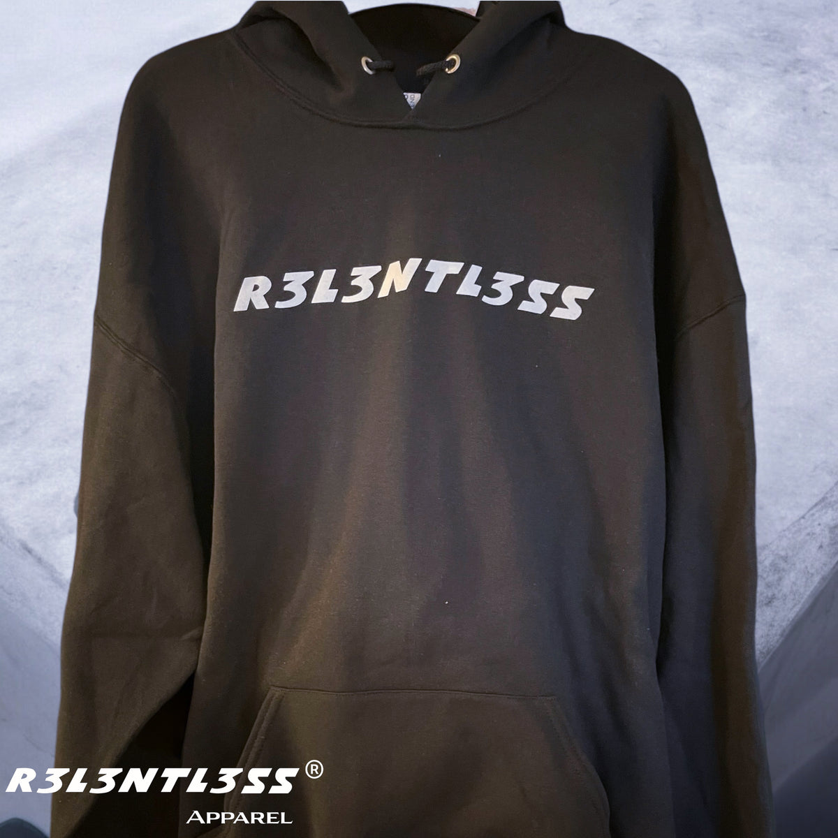 A black hoodie with the text 'R3L3NTL3SS' printed across the front, featuring a hood, pouch pocket, and the brand's logo.