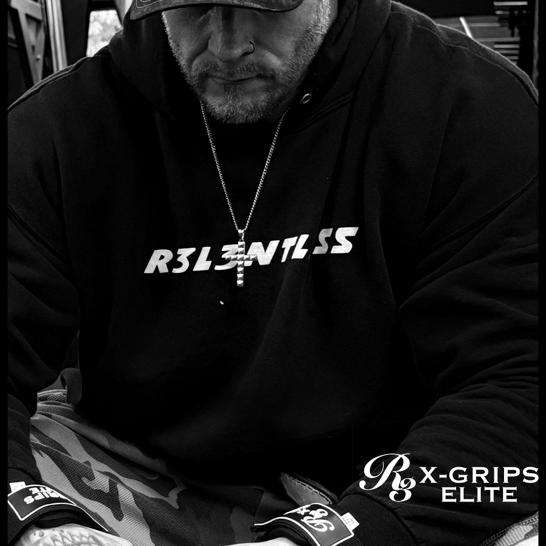 Person wearing a black hoodie with 'R3LENTLESS' logo, sitting outdoors.