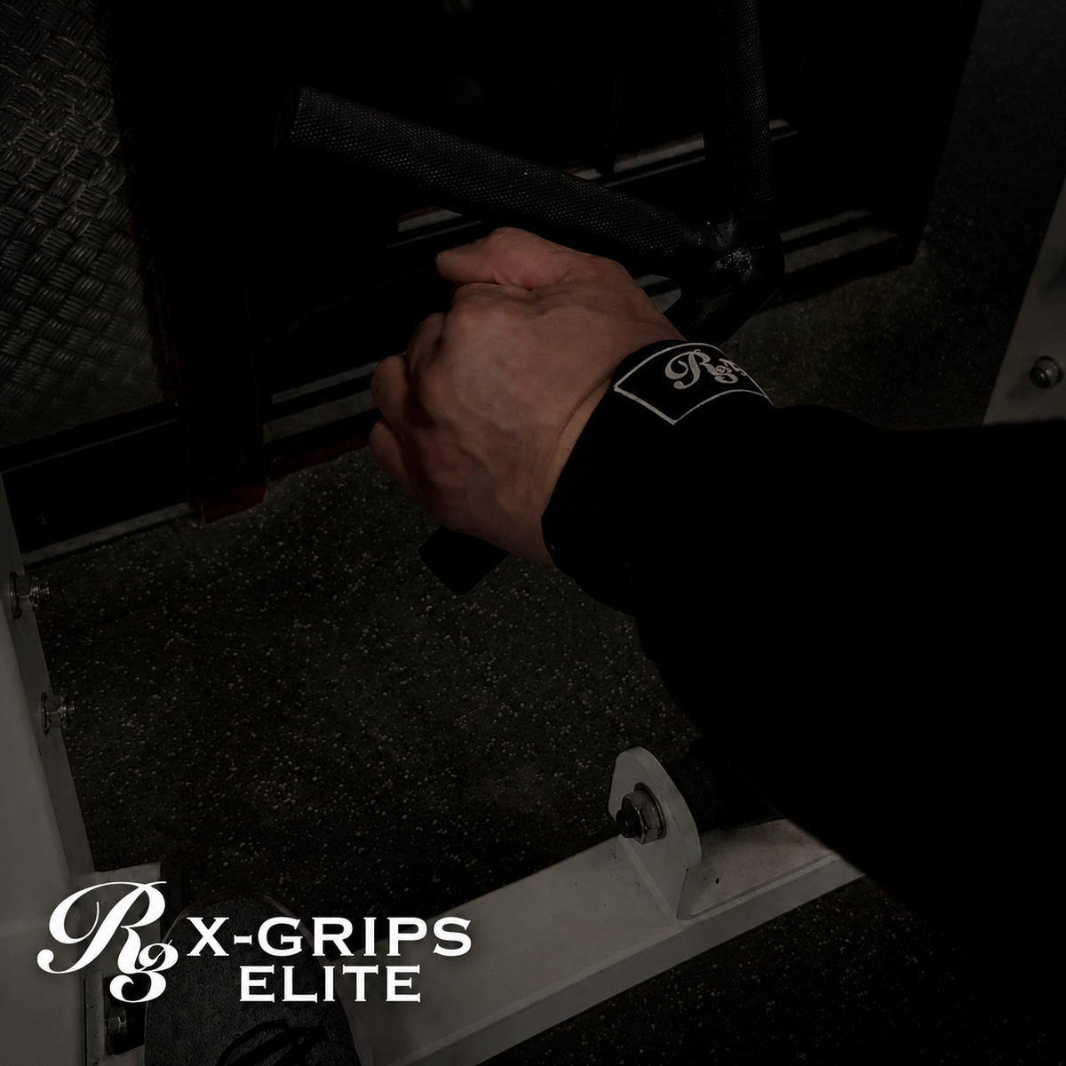 Hand using a tool on a vehicle's floor mat with 'X-Grips Elite' branding.